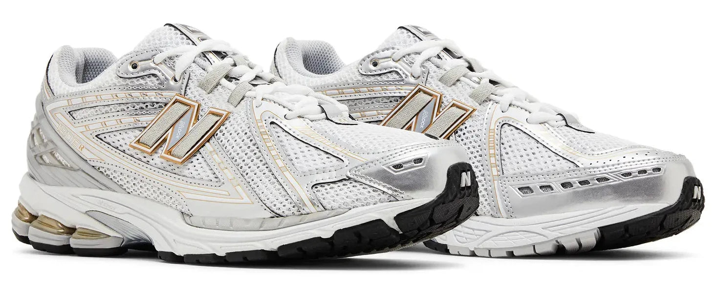 White running shoes with gold accents on a white background