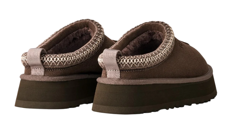 Brown slippers with textured straps on a white background