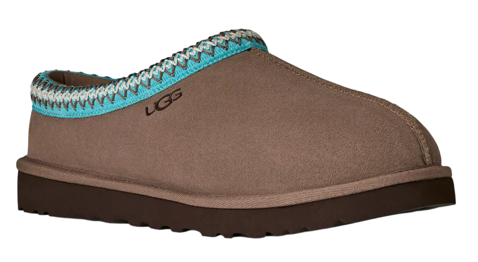 Brown UGG slipper with turquoise and silver trim on a white background