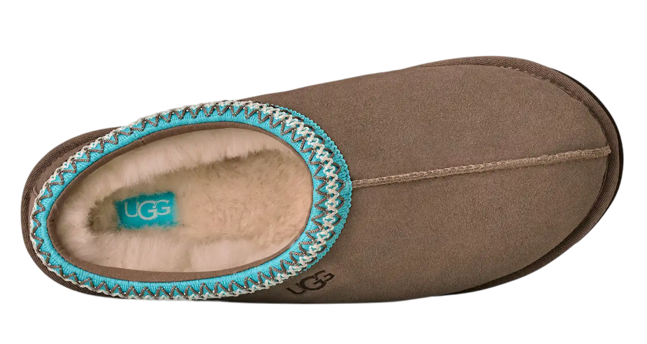 Brown UGG slipper with turquoise trim on a white background