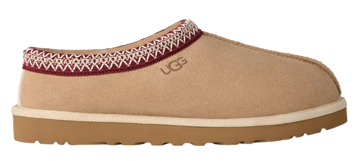 Tan UGG slipper with a white sole on a white background