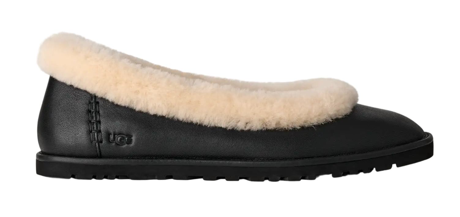 Black slipper with beige fur lining on a white background
