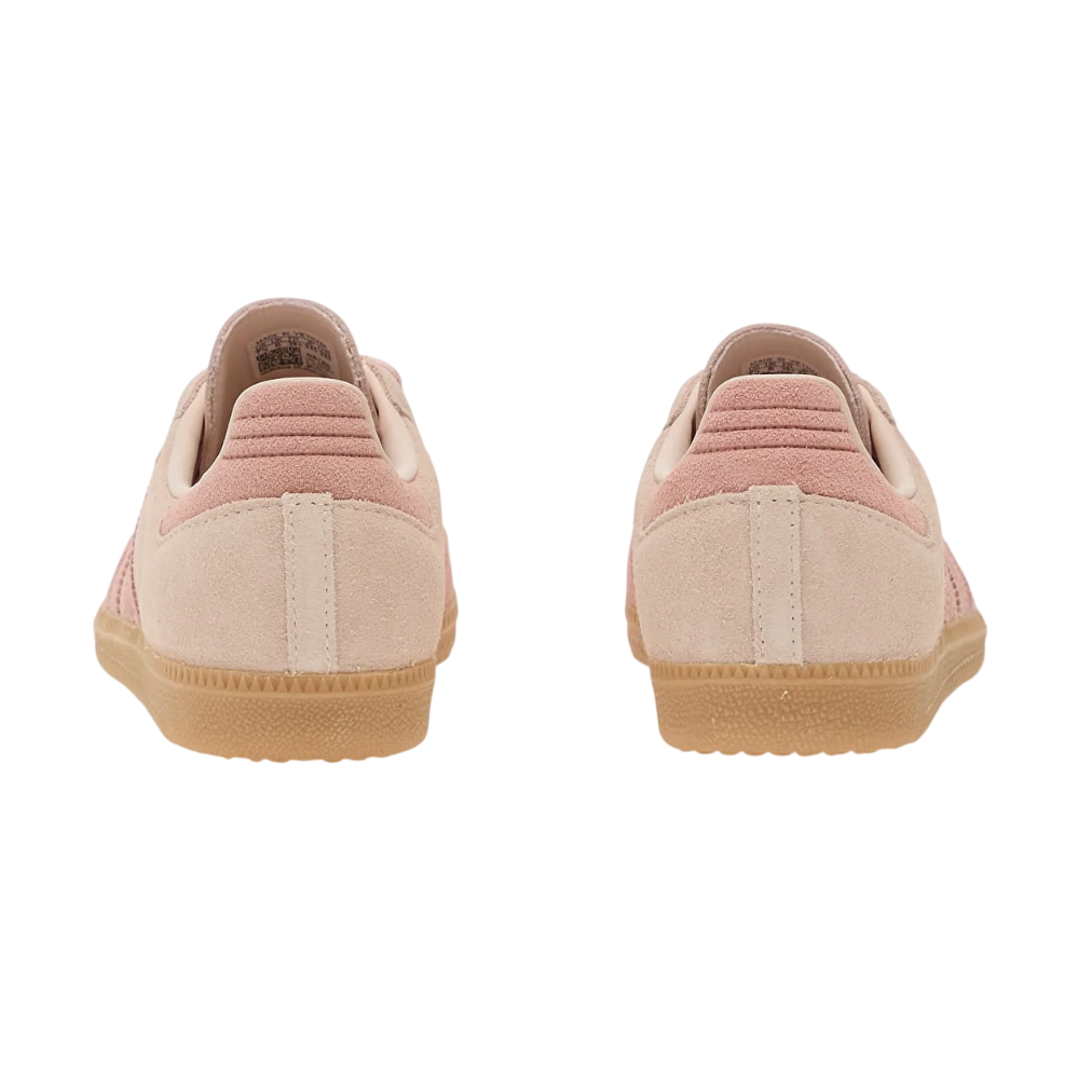Pair of pink sneakers with brown soles on a white background