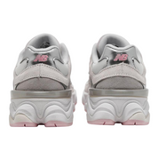 Pair of gray sneakers with pink accents on a white background