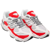 White and red sneakers with gray accents on a white background