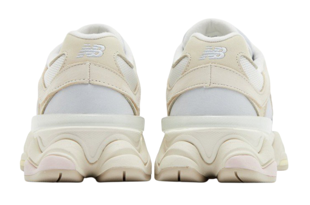 Pair of beige sneakers with white soles on a white background