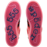 Close-up of red and black athletic shoes with brand logo on sole against a white background - Image 5