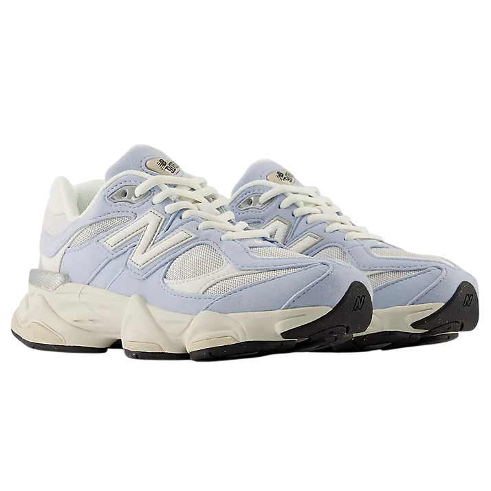 Light blue sneakers with white laces on a white background