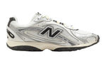 White New Balance sneaker with black logo on a white background - Image 1
