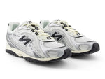 Pair of white New Balance sneakers with black accents on a white background - Image 2