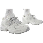 White sneakers worn with white socks on a white background - Image 2