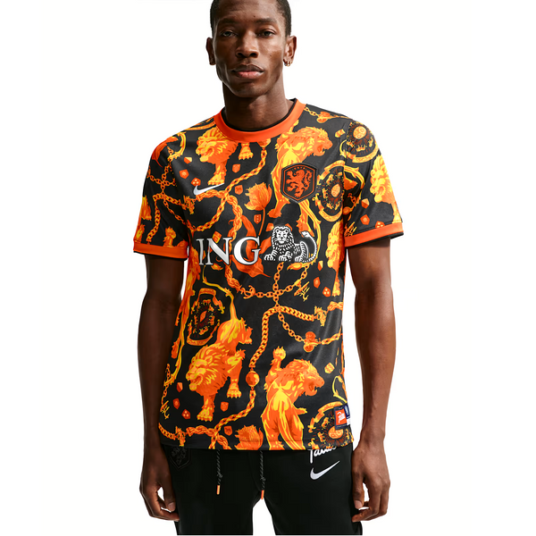 Person wearing a black and orange patterned sports jersey with visible branding on a white background